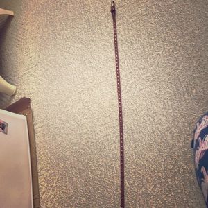 A brown skinny gold studded brown belt